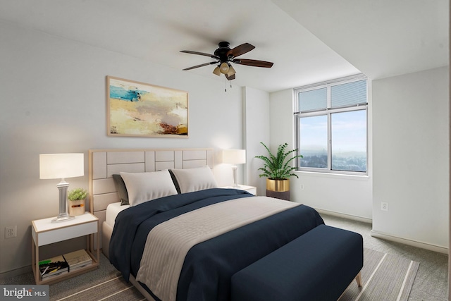 carpeted bedroom featuring baseboards and ceiling fan