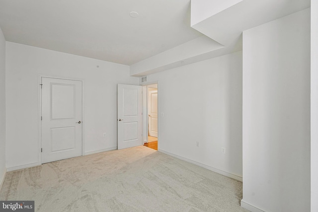 unfurnished bedroom featuring visible vents, baseboards, and carpet