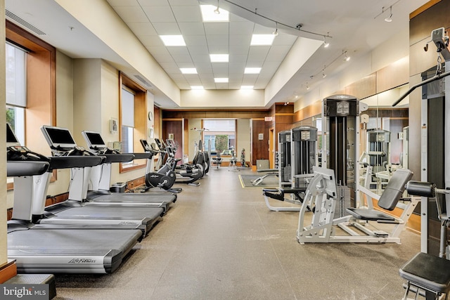 gym featuring visible vents, a paneled ceiling, and track lighting