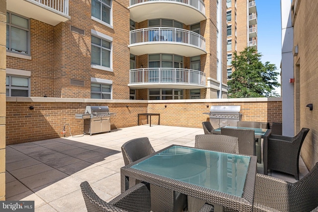 view of patio with an outdoor kitchen, outdoor dining space, and a grill