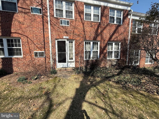 rear view of house featuring brick siding