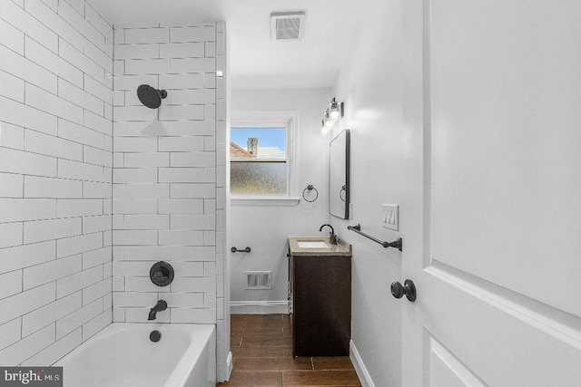 bathroom featuring vanity,  shower combination, wood finished floors, and visible vents