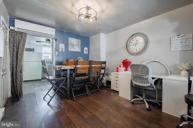 dining space with hardwood / wood-style flooring, an inviting chandelier, and a wall mounted AC