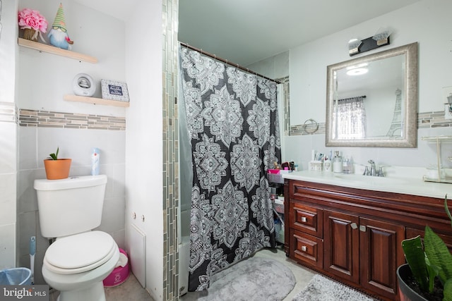 full bath with a shower with curtain, toilet, tile walls, and vanity