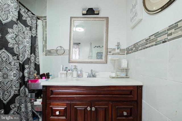 bathroom with vanity and tile walls