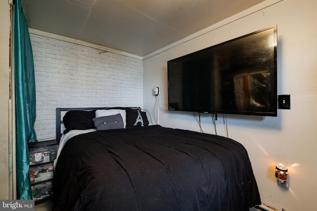 bedroom with brick wall