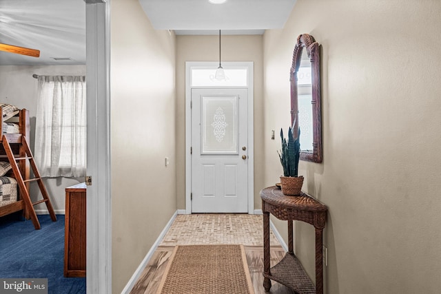 doorway to outside featuring baseboards