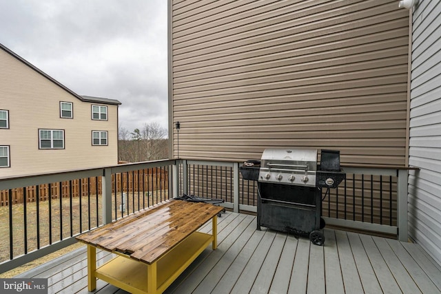 wooden terrace featuring a grill