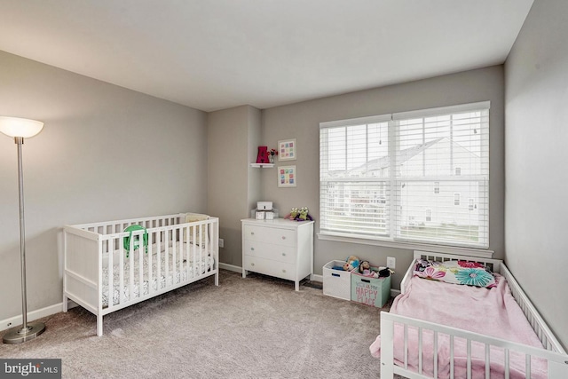 bedroom featuring carpet and baseboards