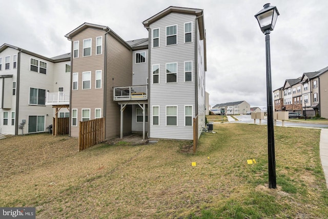 back of house featuring a residential view and a yard