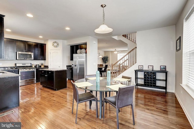 dining space featuring recessed lighting, visible vents, baseboards, stairs, and light wood finished floors