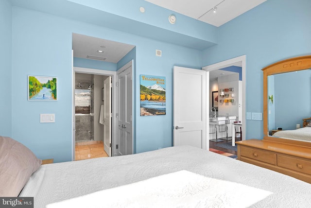 bedroom featuring visible vents and ensuite bathroom