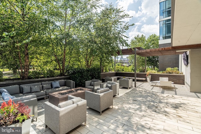 view of patio / terrace with an outdoor living space with a fire pit and a pergola