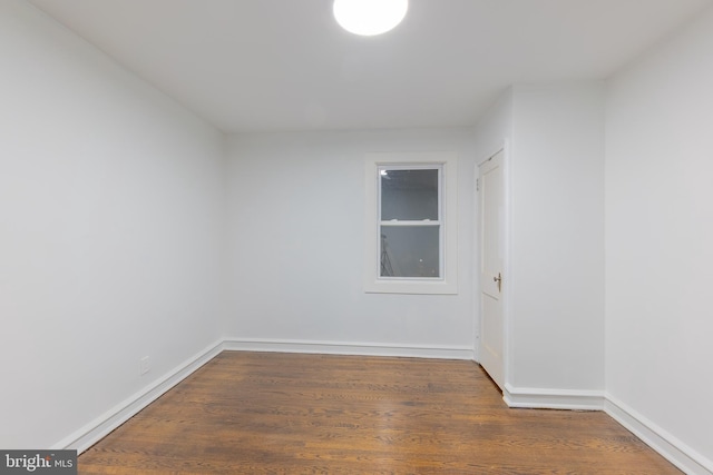 empty room featuring baseboards and wood finished floors