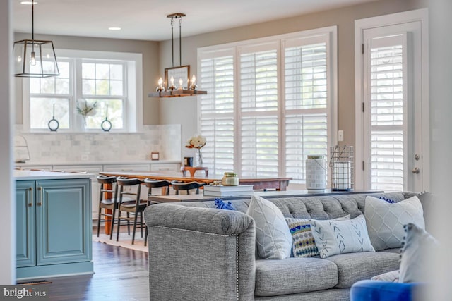 living area featuring dark wood-style floors and a chandelier