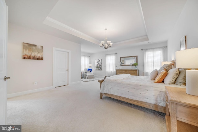 bedroom with a chandelier, baseboards, ornamental molding, a tray ceiling, and carpet