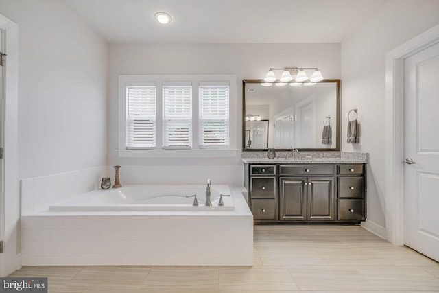 full bath with a garden tub and vanity