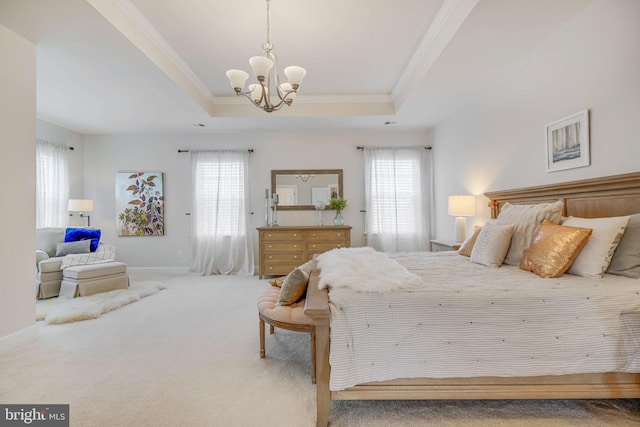 carpeted bedroom with a tray ceiling, multiple windows, crown molding, and a notable chandelier