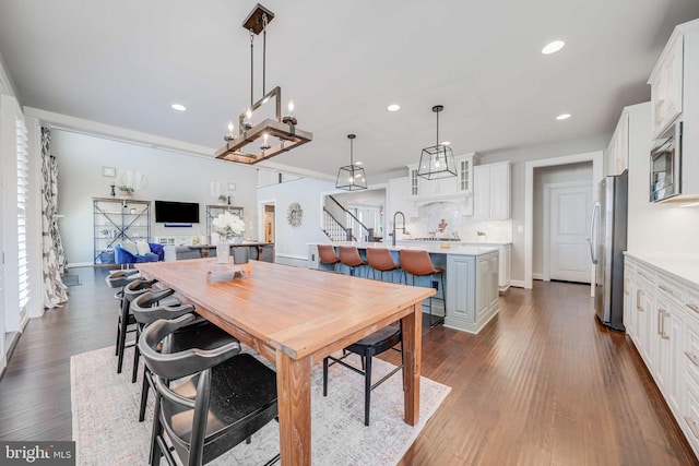 dining room featuring baseboards, stairway, dark wood finished floors, and recessed lighting