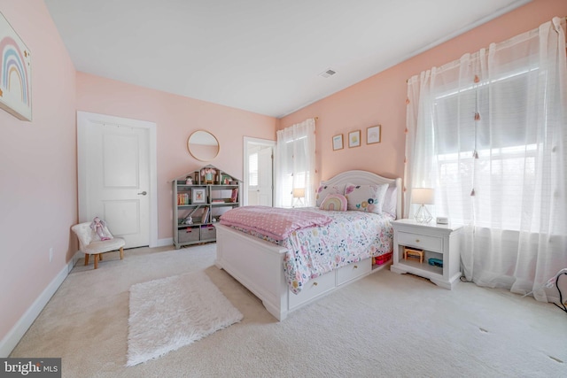 bedroom with baseboards, visible vents, and light colored carpet