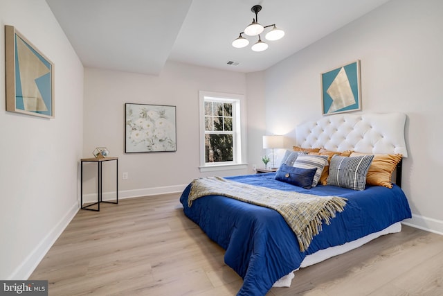 bedroom featuring wood finished floors and baseboards