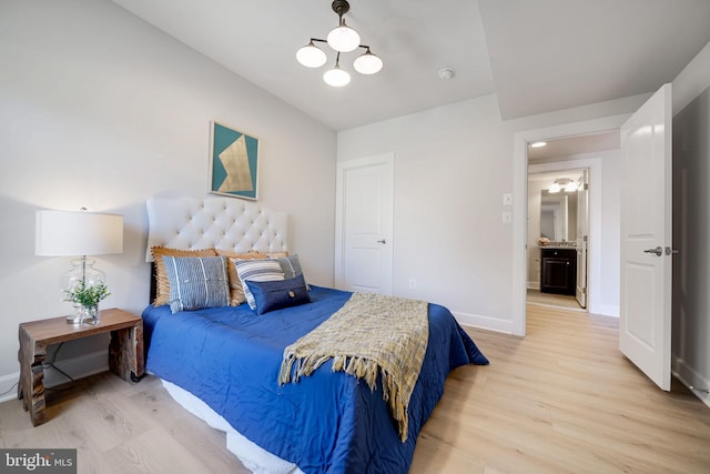 bedroom featuring baseboards and light wood finished floors