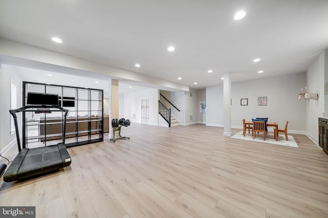 exercise room with light wood-style floors, baseboards, and recessed lighting