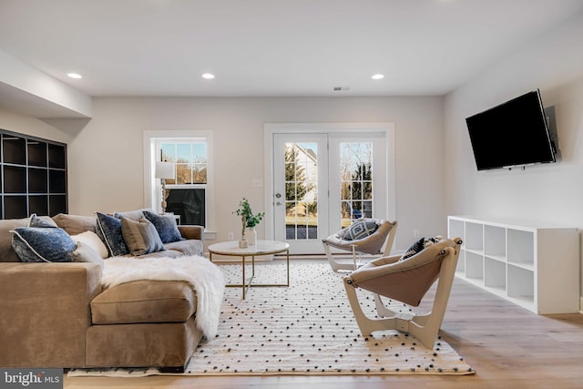 living room featuring wood finished floors, visible vents, and recessed lighting