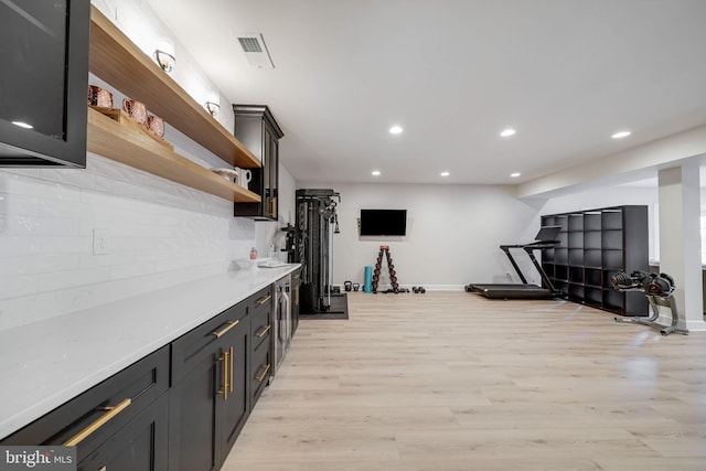 interior space featuring open shelves, tasteful backsplash, recessed lighting, light countertops, and light wood-style floors