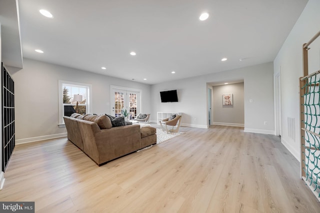 living room with baseboards, light wood-style floors, and recessed lighting