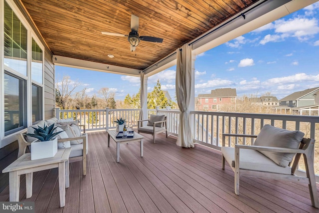 deck featuring a residential view, ceiling fan, and an outdoor living space