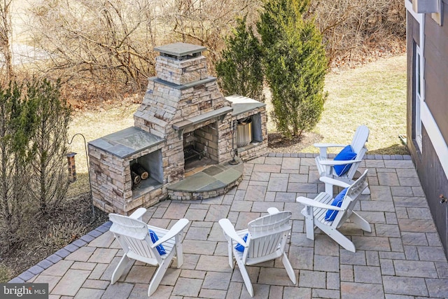 view of patio / terrace with an outdoor stone fireplace