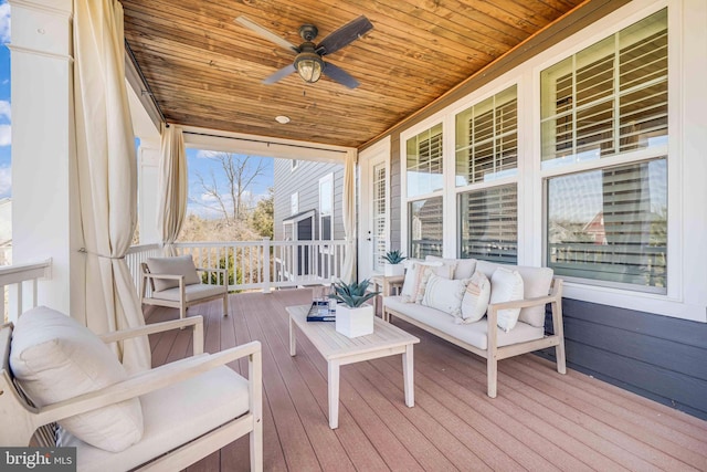 wooden terrace featuring outdoor lounge area and a ceiling fan