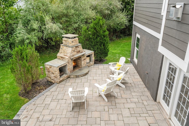 view of patio / terrace with an outdoor stone fireplace