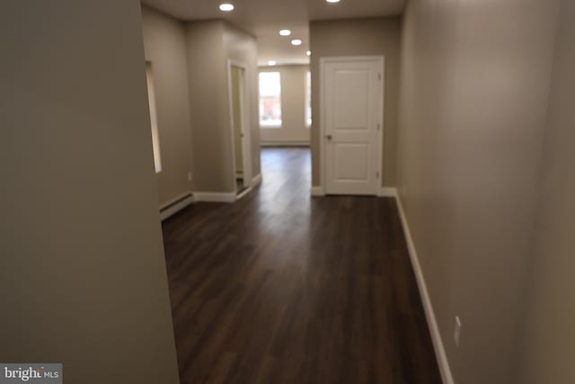 hall featuring recessed lighting, a baseboard radiator, baseboards, and dark wood-style floors