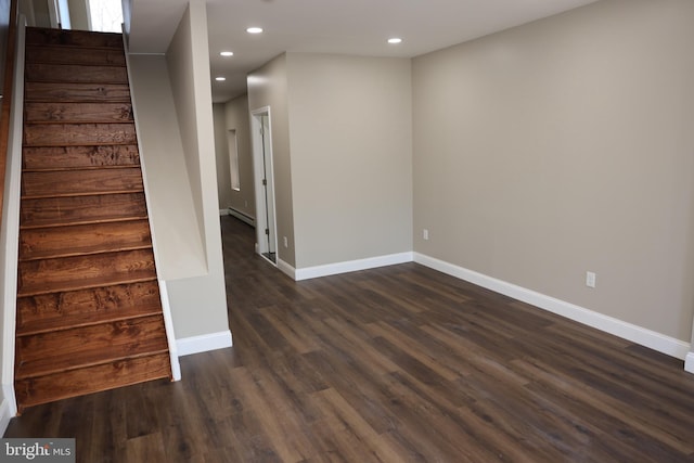 spare room featuring baseboards, stairway, baseboard heating, recessed lighting, and dark wood-style floors