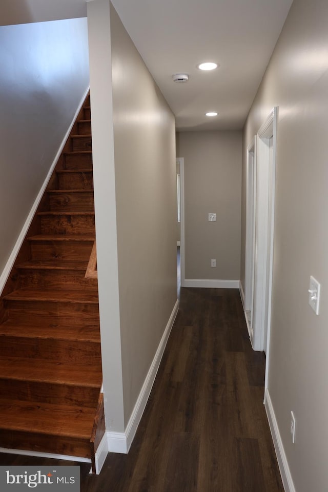 hallway with recessed lighting, baseboards, dark wood-style floors, and stairs