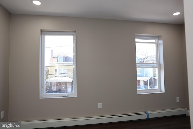 unfurnished room with a baseboard heating unit and recessed lighting