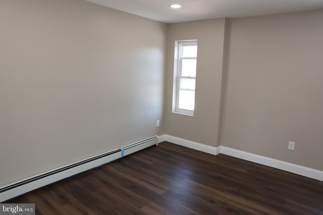 spare room featuring recessed lighting, baseboards, dark wood-style flooring, and a baseboard radiator