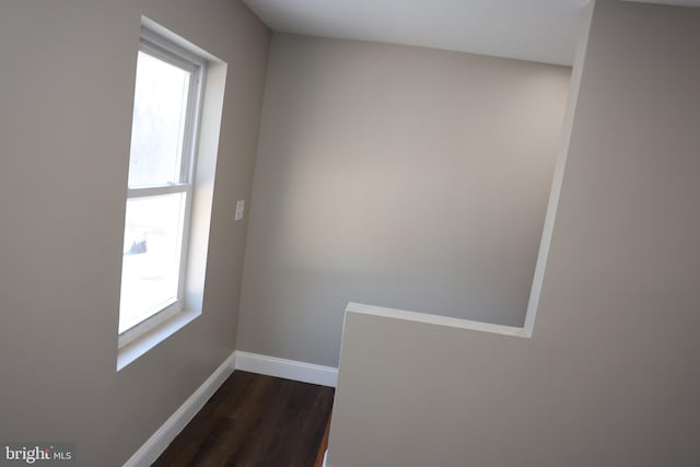 interior space with dark wood-type flooring and baseboards