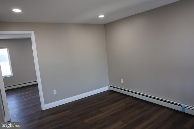 unfurnished room featuring dark wood-type flooring, baseboards, baseboard heating, recessed lighting, and a baseboard radiator