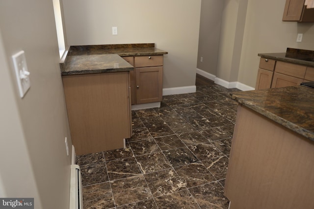 kitchen with baseboards and marble finish floor