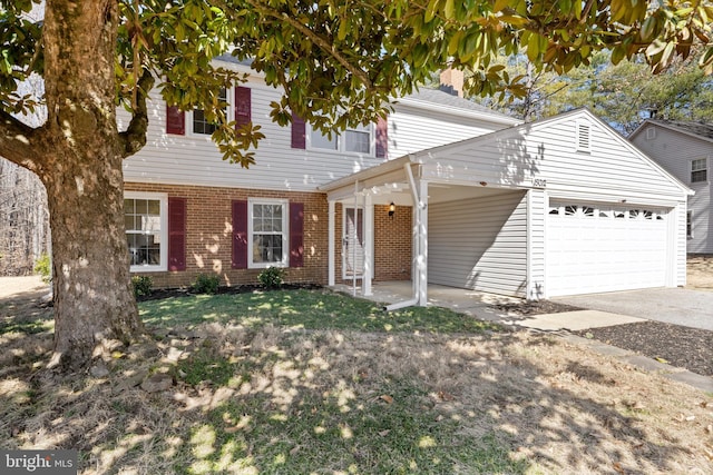 view of front facade with driveway, brick siding, and an attached garage