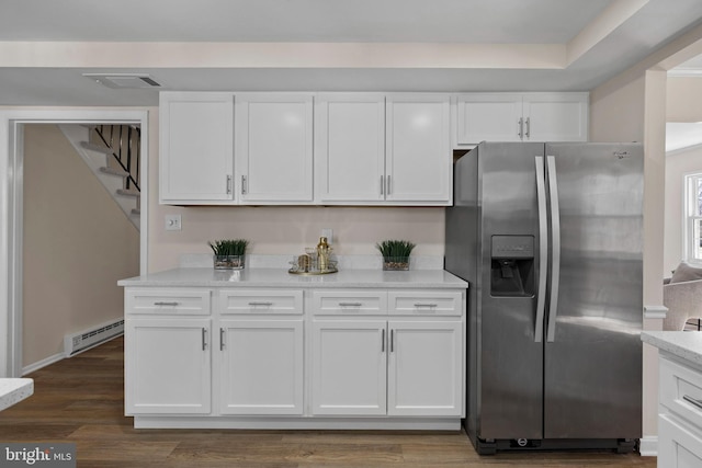 kitchen featuring visible vents, white cabinets, baseboard heating, stainless steel refrigerator with ice dispenser, and dark wood-style floors