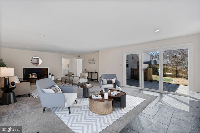 living area with a fireplace and recessed lighting