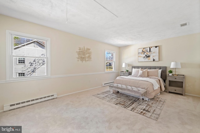 carpeted bedroom with multiple windows, a baseboard radiator, and baseboards