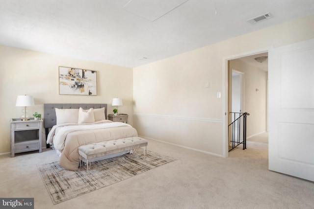 bedroom featuring carpet floors, visible vents, and baseboards