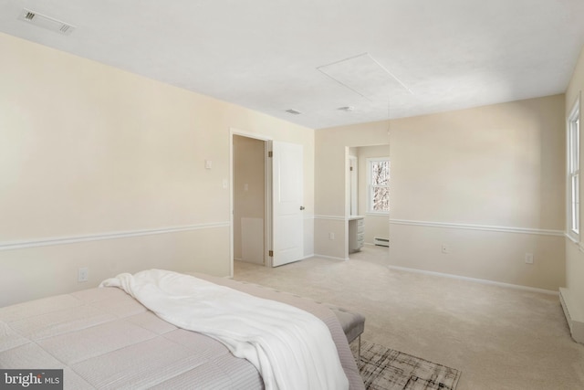 bedroom featuring a baseboard radiator, light colored carpet, visible vents, baseboards, and attic access