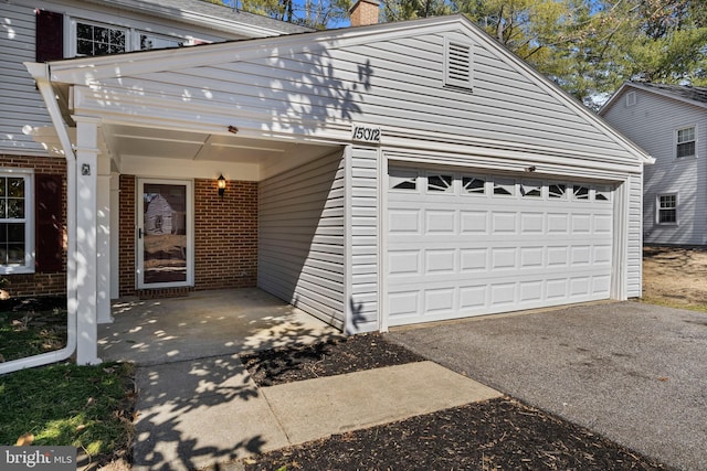 exterior space with a chimney and brick siding