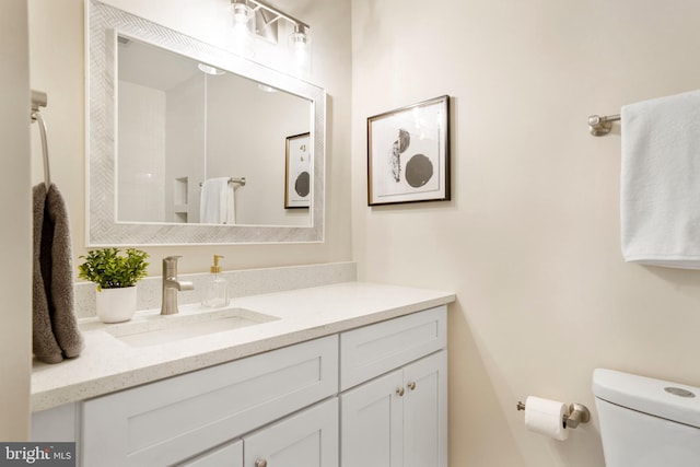 bathroom featuring vanity and toilet